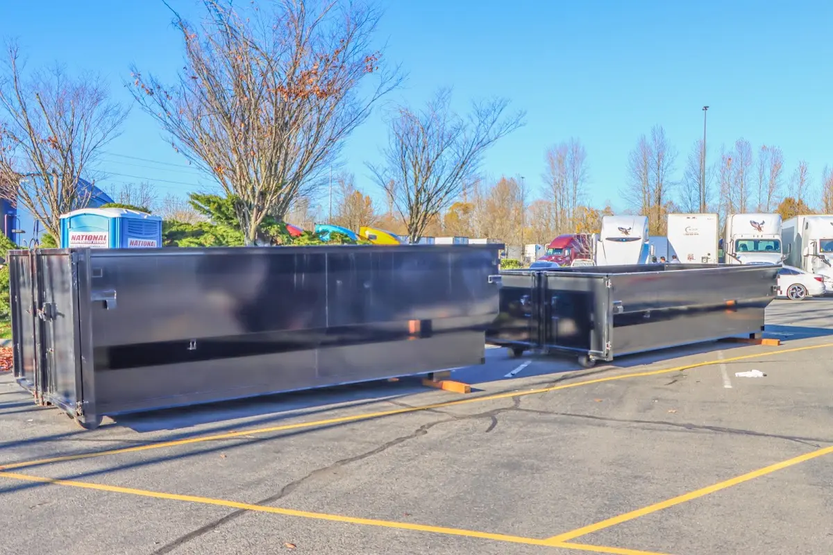 Professional dumpster rental service with roll-off container on residential driveway in Maxatawny